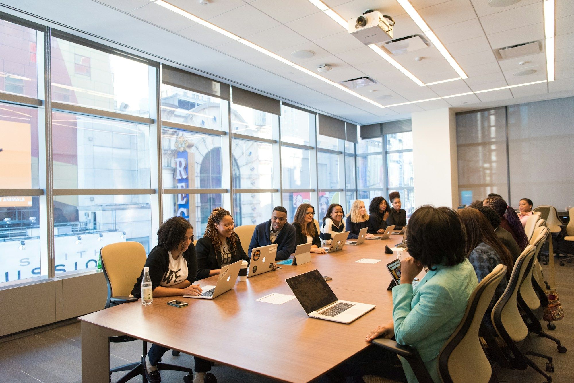 Managers and staff in a workshop around a boardroom table